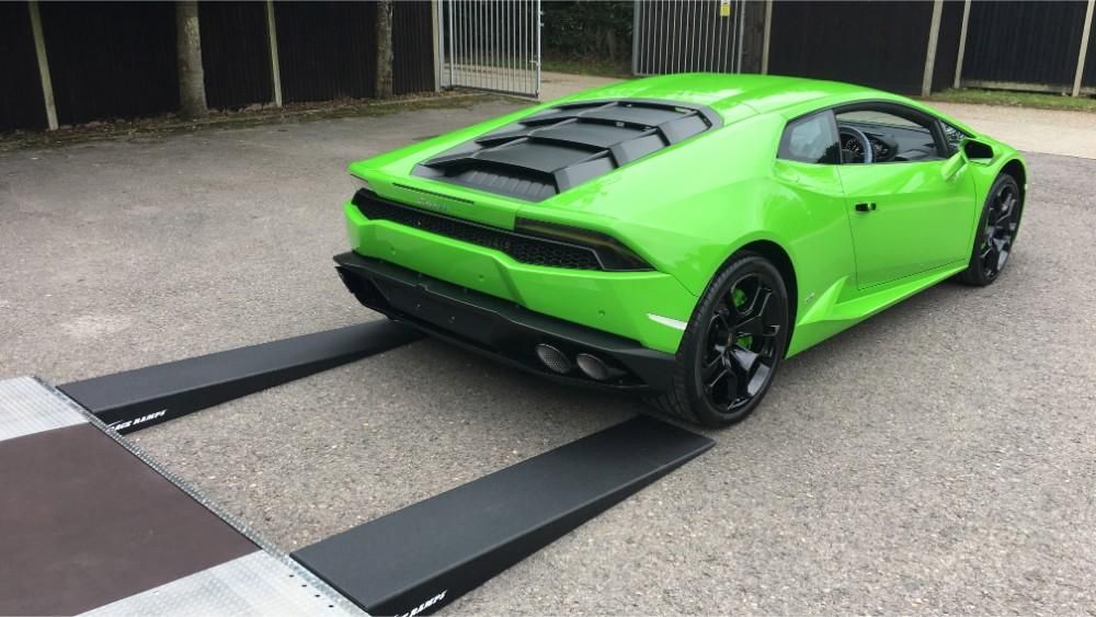 green sports car being unloaded from our truck
