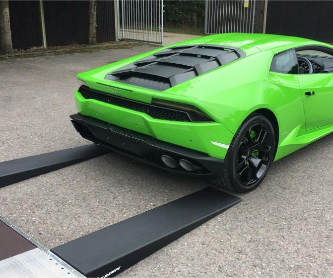 green sports car being unloaded from our truck