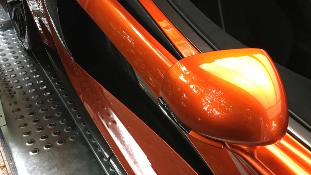 orange sports car wing mirror