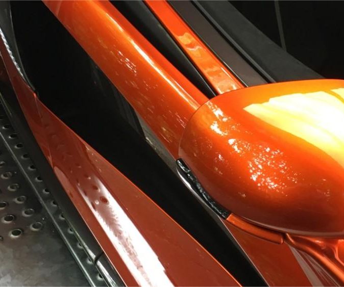 orange sports car wing mirror