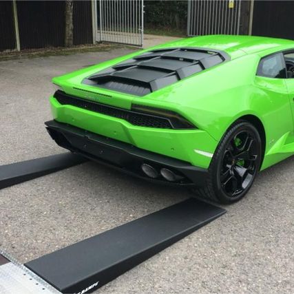 green sports car being unloaded from our truck