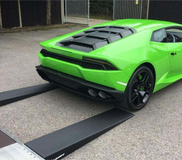 green sports car being unloaded from our truck