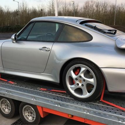 grey car being transported